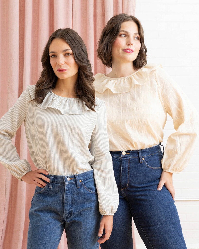 Two women stand together modeling the front side of the blouse