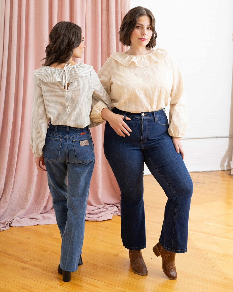 Two women stand together modeling the back side of the blouse