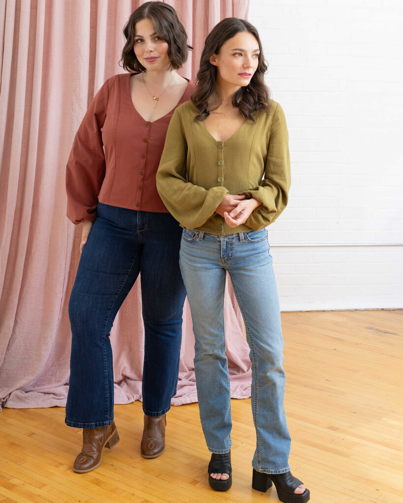 Morgan modeling a pink blouse and Sarah modeling a green blouse