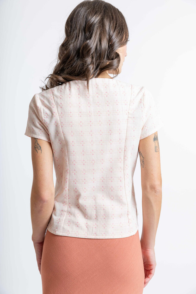 Sarah modeling the back of the Sage blouse with cap sleeves in pink yarn dyed cotton