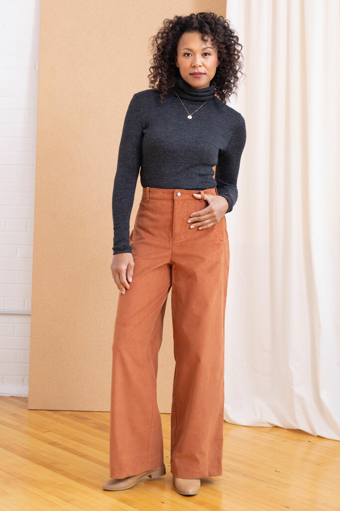 A model wearing a fitted turtleneck top and wide legged trousers. Both are Seamwork sewing patterns.