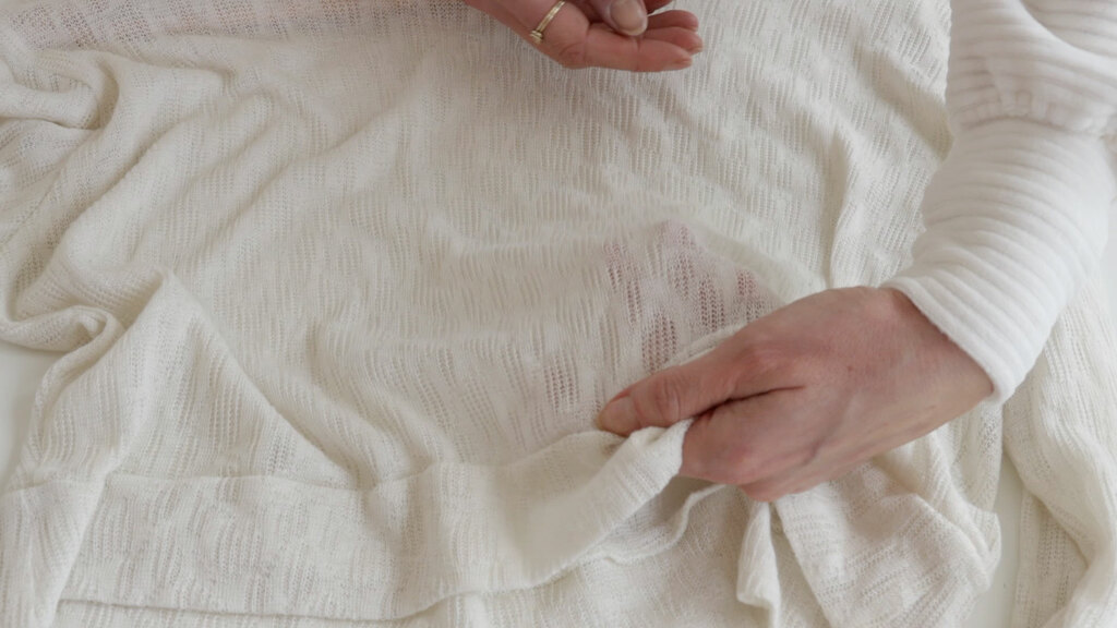 a sheer, lacy sweater knit fabric