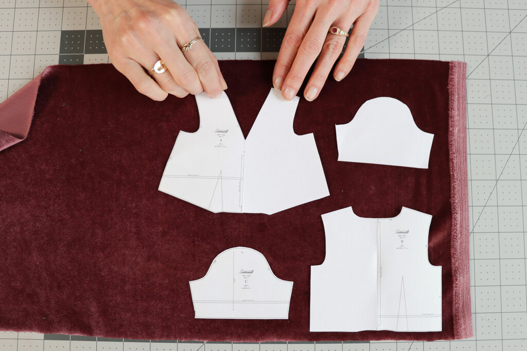 Fabric pieces laid out on velvet fabric, all facing the same direction