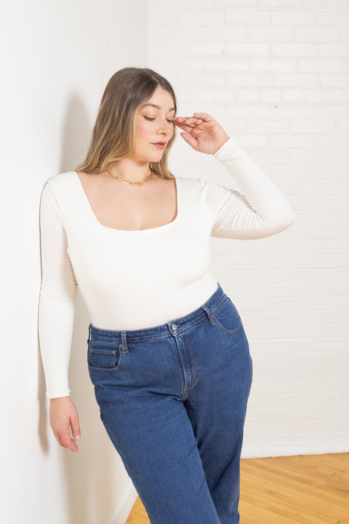 Woman modeling white Ione bodysuit