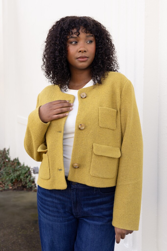Woman wearing the lime green Rhoda jacket