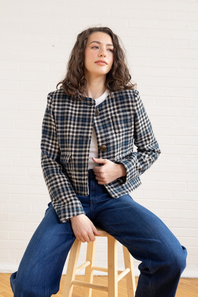 Woman wearing the checkered Rhoda jacket