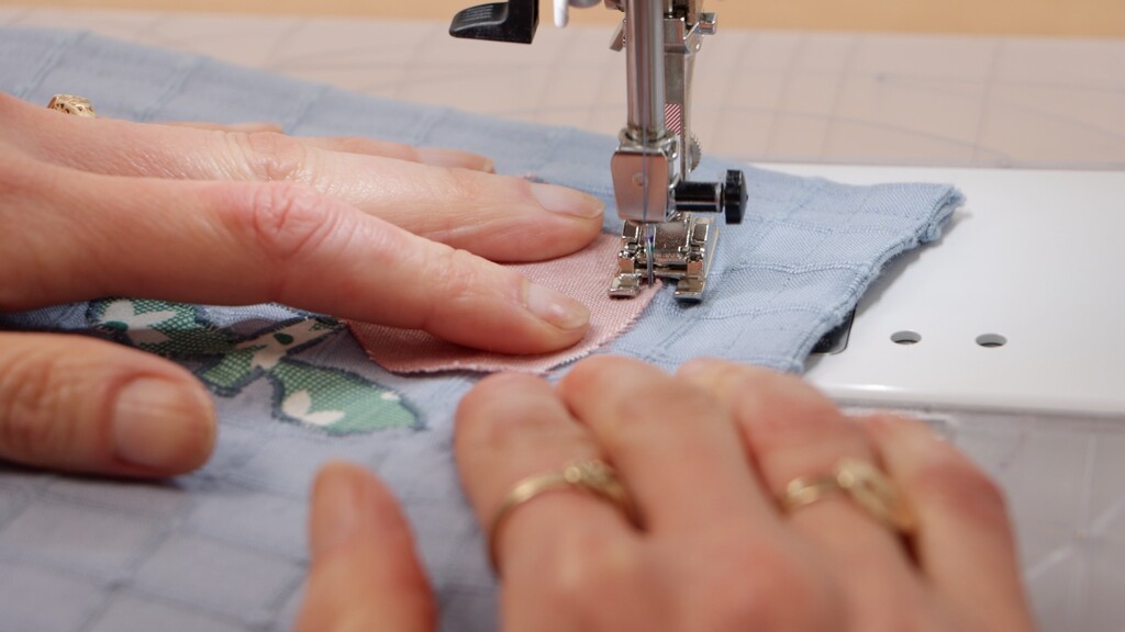 Open embroidery foot showing wide opening and channel underneath