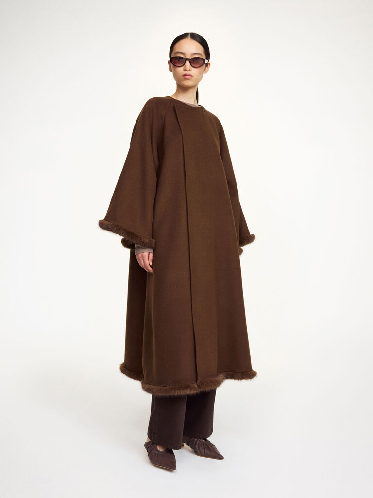 Close-up of coat hem with faux fur trim attached