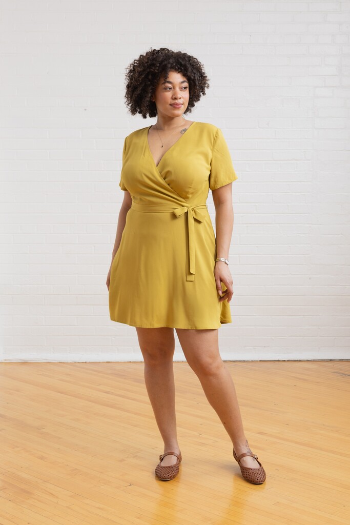 Model wearing a lime green Posie dress