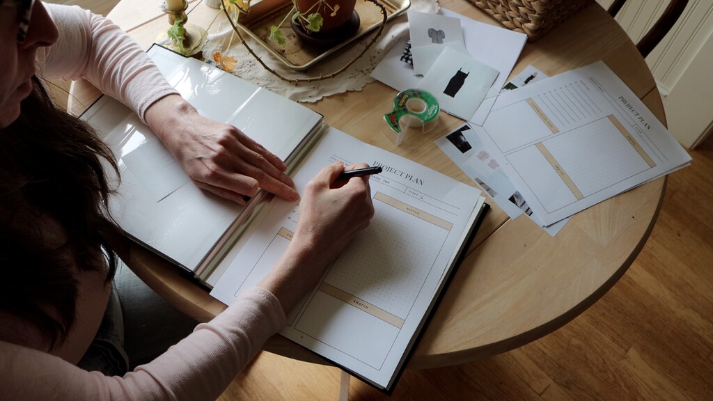 The Seamwork free wardrobe planner open to a planning spread, showing space for moodboard images, project notes, fabric swatches, and outfit combinations