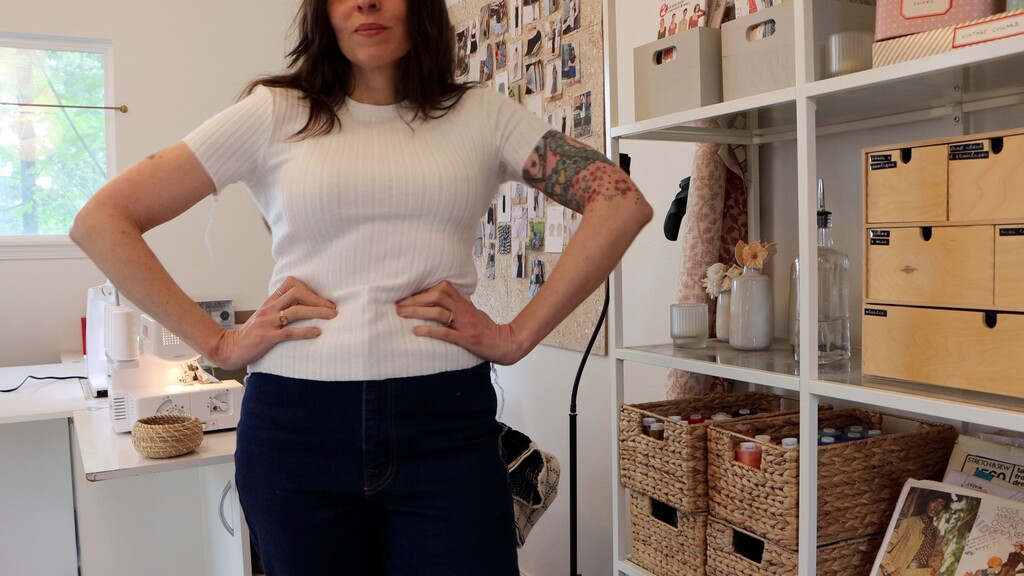 The tee being tried on mid-construction, before hemming, showing the fit through the shoulders and body