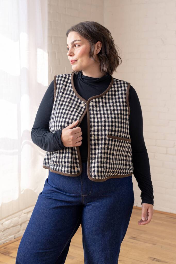 Model wearing a checkered black and white Moss vest